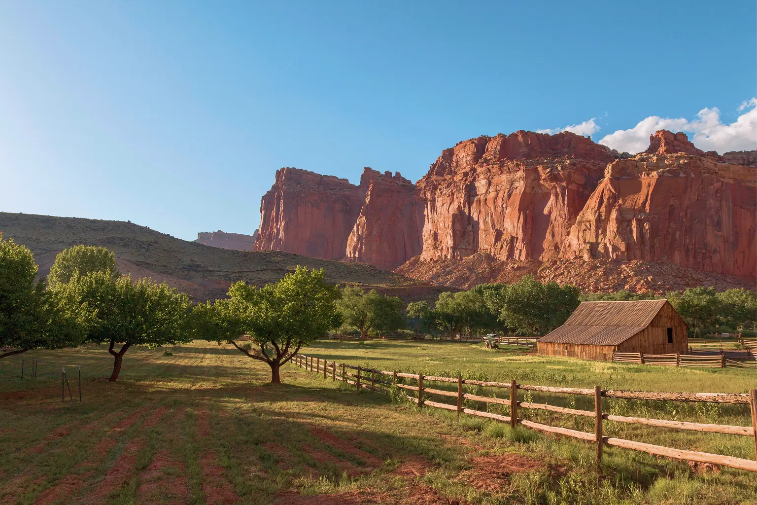 Historic Gifford barn and orchard beneath the red rock cliffs of Capitol Reef National Park